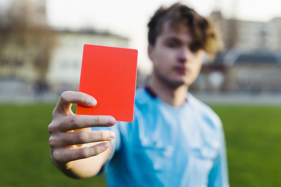 a man holding a red card