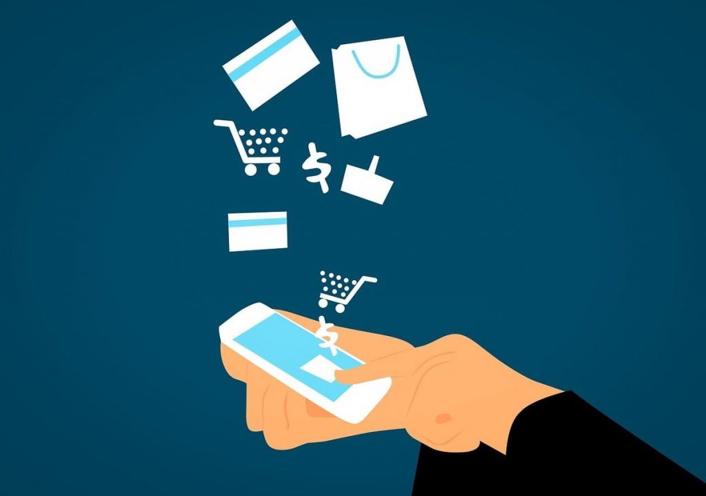 An illustration of a hand purchasing on an online store via a smartphone